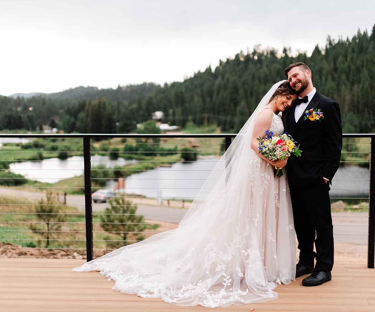 Newlyweds on balcony with lake views - Lake View at Mountain View Ranch