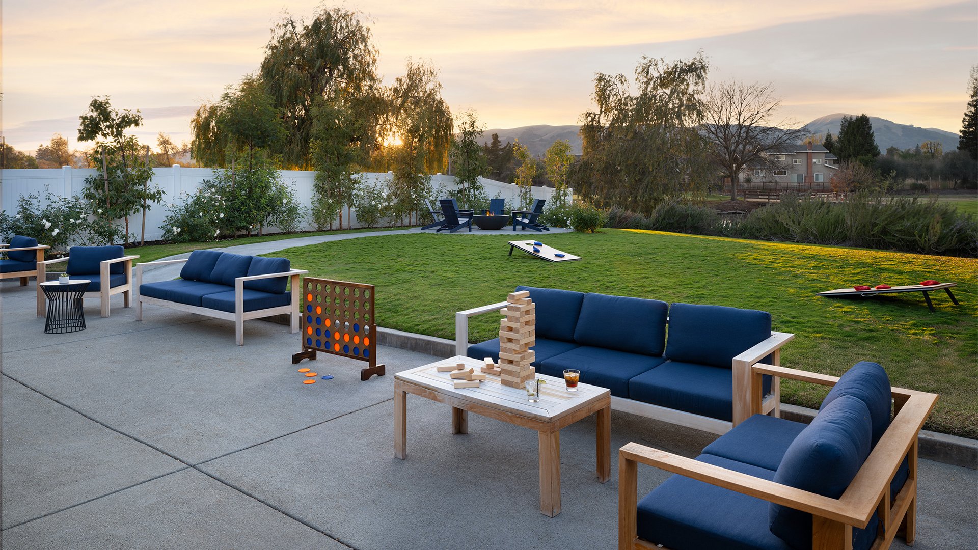 Outdoor Games and Lounge Area with Connect Four and Custom Seating at Dusk