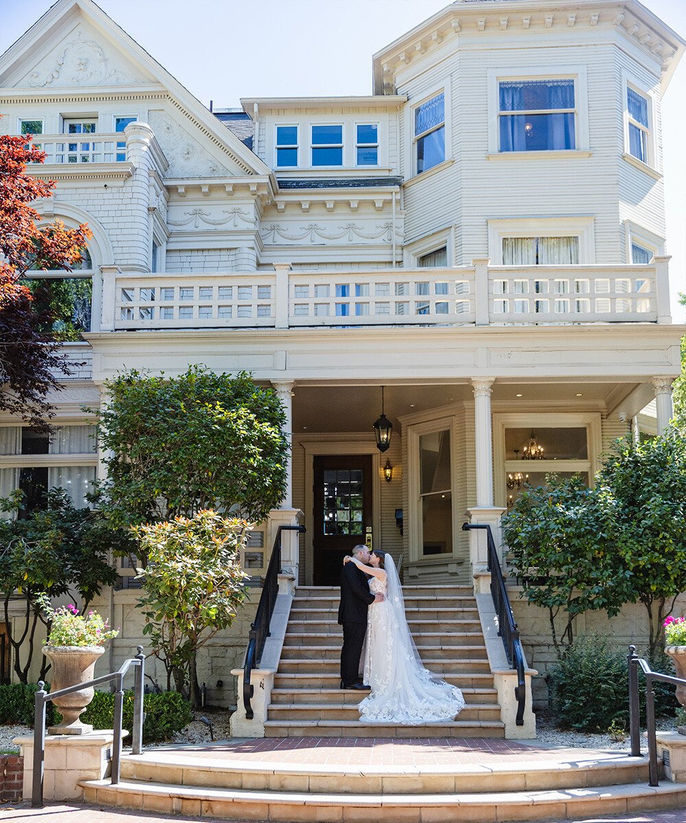 Couple in front of historic Sterling Hotel by Wedgewood Weddings