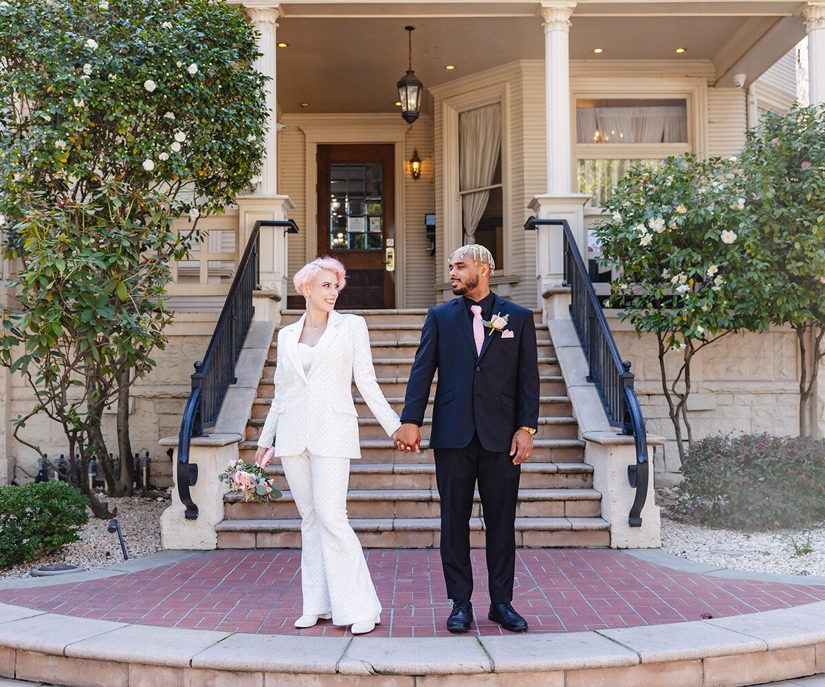 Happy couple posing out front of staircase - Sterling Hotel by Wedgewood Weddings