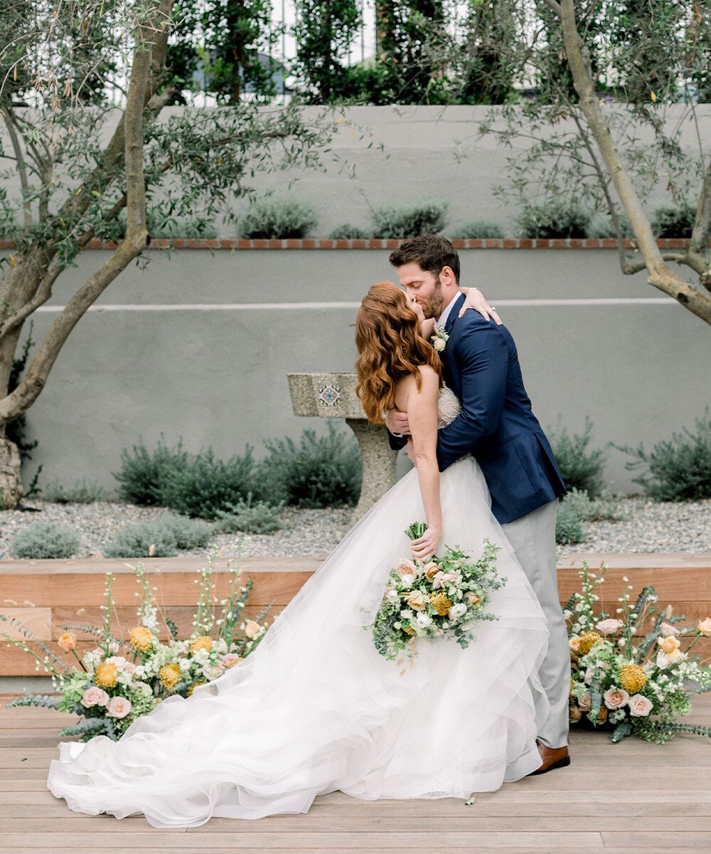 Romantic couple portraits at The Harper surrounded by olive trees and climbing vines - modern Costa Mesa wedding venue backdrop