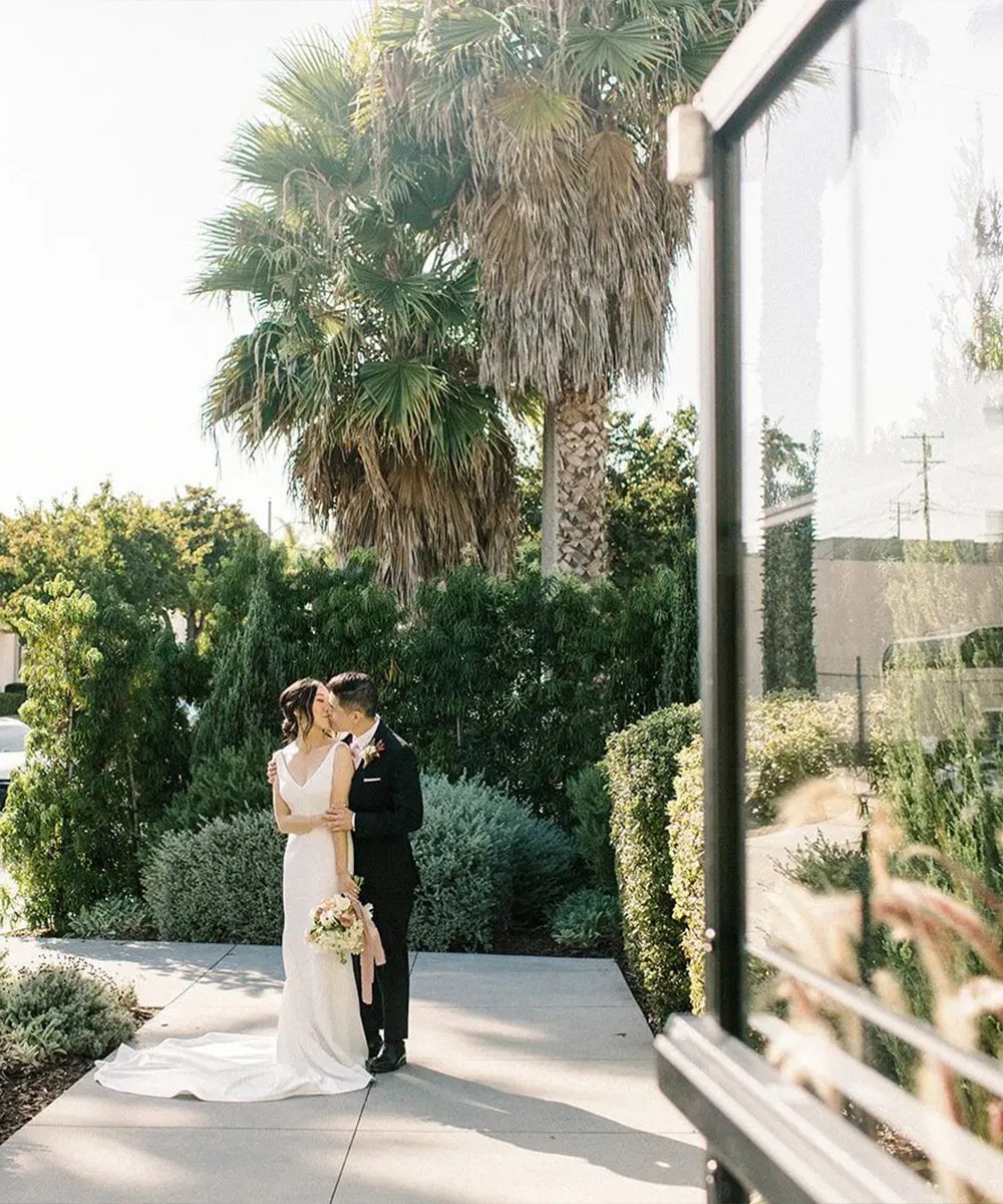 The Harper's lush courtyard with California palm trees and Mediterranean garden provides an intimate setting for wedding portraits