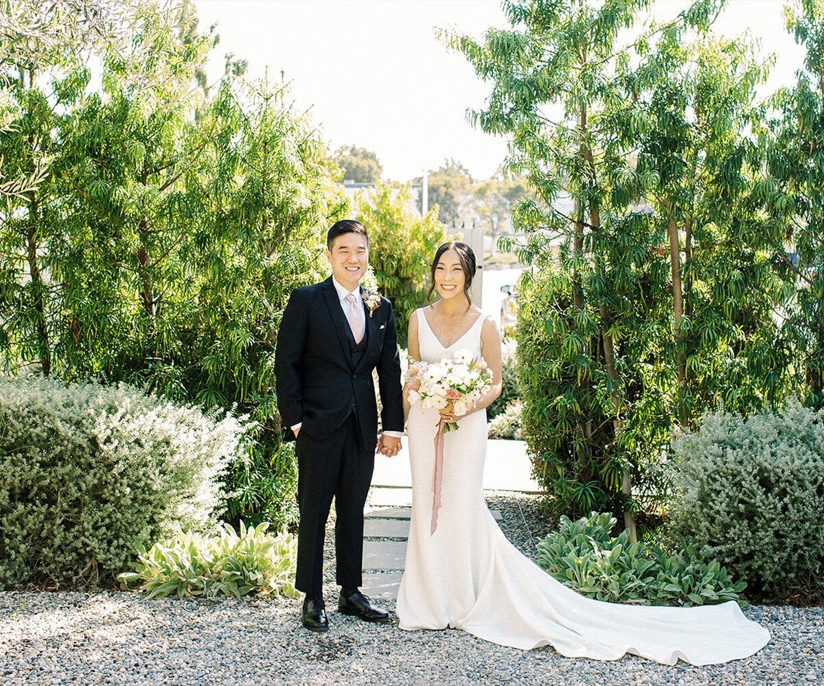 Garden wedding portraits at The Harper Costa Mesa surrounded by lush greenery and California landscaping