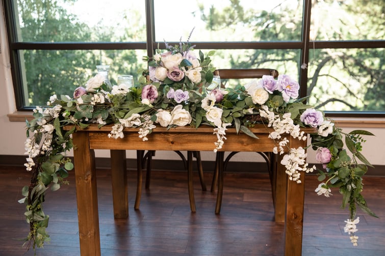 Sweetheart table with purple flowers - The Pines