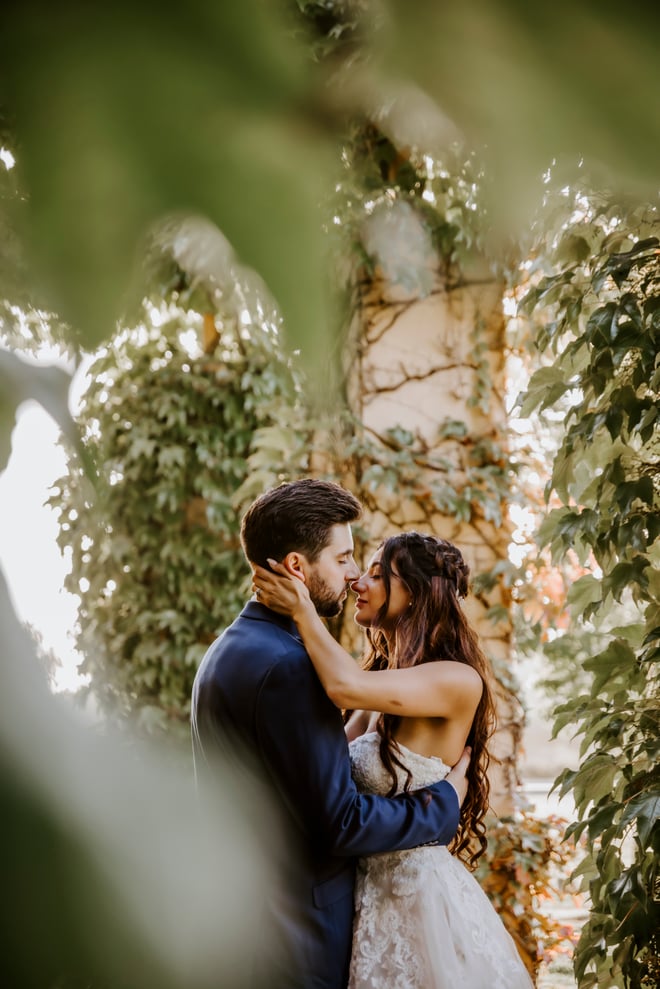 Juliet and Andrew with greenery and twinkle lights