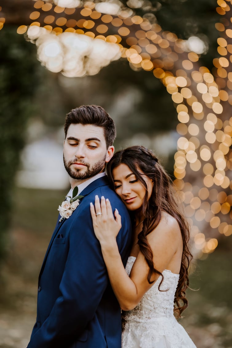 Juliet and Andrew in front of the twinkle lights