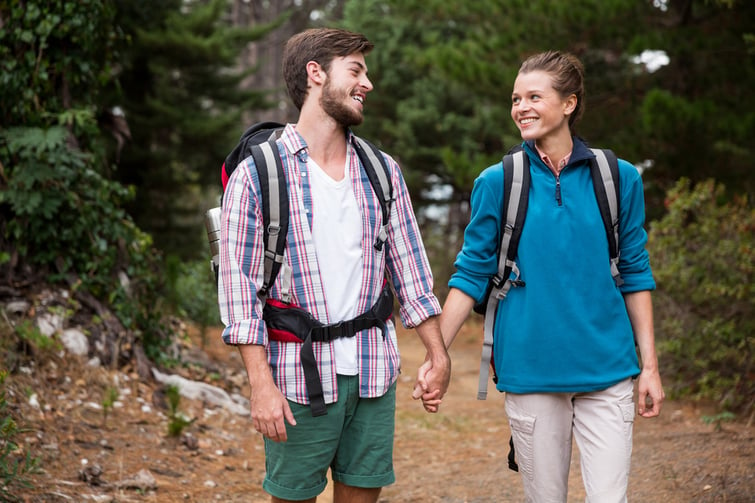 Couple hiking through a forest in the countryside