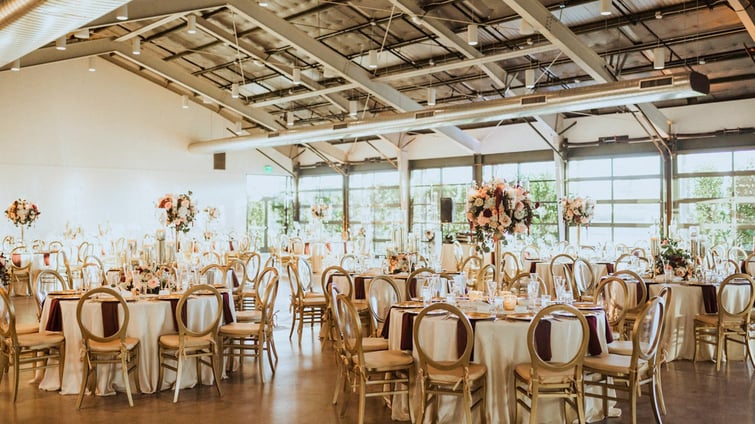 Windowed walls open to The Patio from The Hangar reception space for a bright and airy atmosphere at Clayton House by Wedgewood Events