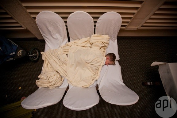 boy asleep on chairs